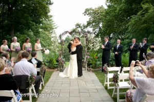 Wedding ceremony first kiss in garden, Artful Weddings by Sachs Photography