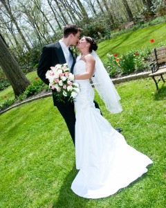 Bride and Groom in Garden Kissing Artistic Difference