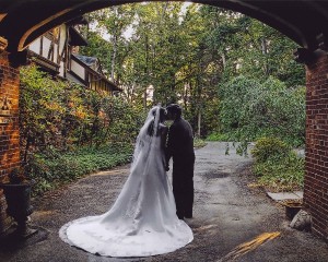 Bride and Groom Kissing Under Porte Coche