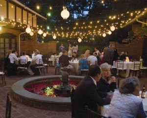 Carriage House courtyard dining with lights and lanterns