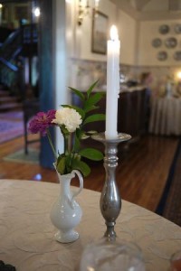 Candle and flower on dining room breakfast table