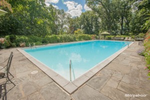 pool and patio with garden view
