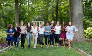 Group of women walking in the outdoor gardens smiling and laughing.