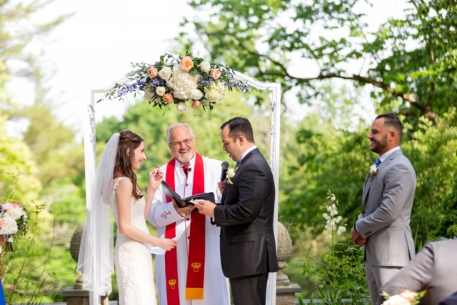 Outdoor ceremony with couple laughing.