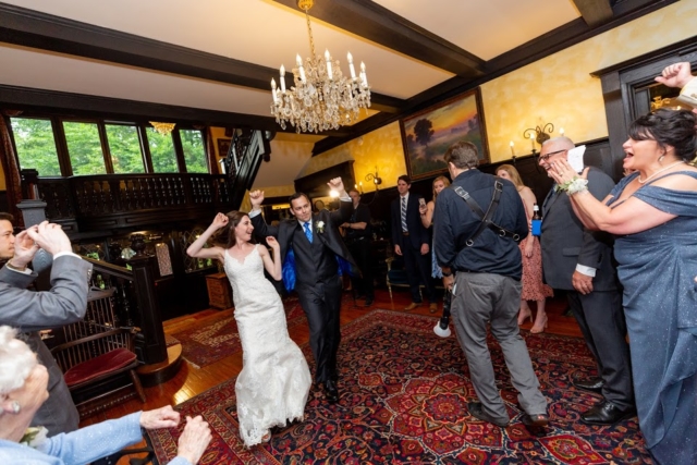 Couple dancing at their wedding in a mansion.