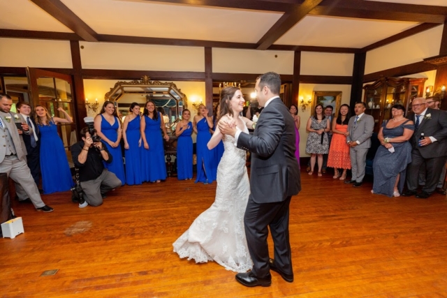 Dancing in the mansion. Couple in a white dress and gray suit.